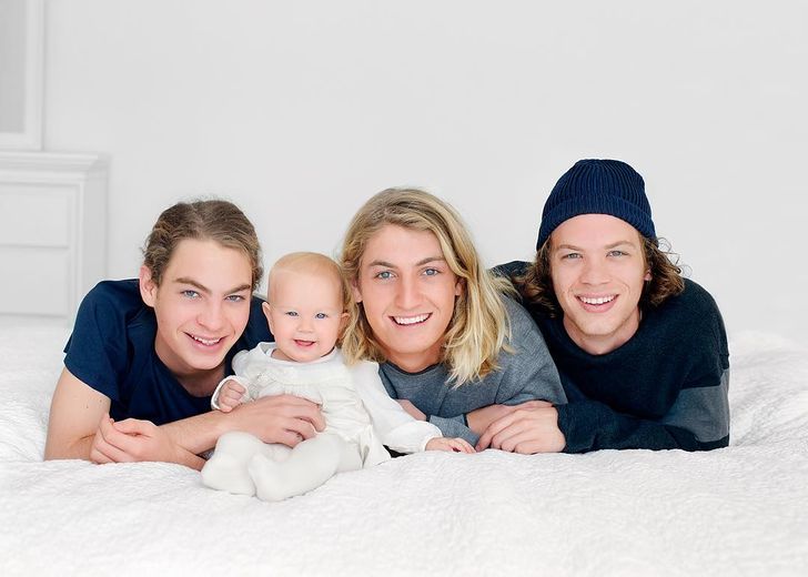 Boys are photographed with their younger sister 