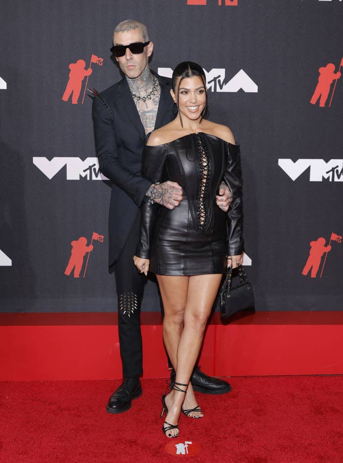 Kourtney Kardashian posing in a photo with travis baker 