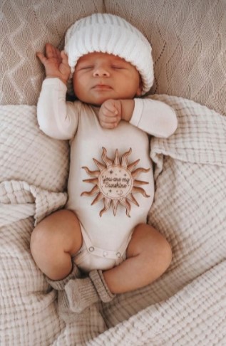 Baby lying in a crib sleeping