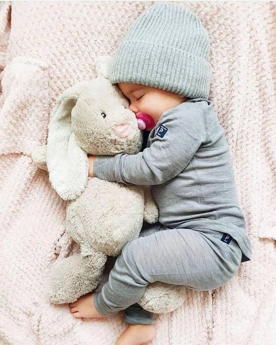 Baby lying in a crib sleeping