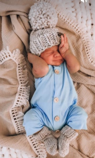 Baby lying in a crib sleeping