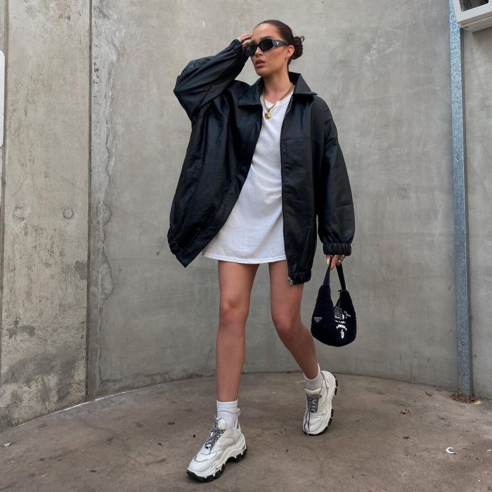 girl, girl, woman with short, long, brown, blond, light, dark hair wearing white tennis shoes, jeans, pants, sweatshirt, coat, oversized blouse, bag, accessories, leather jacket