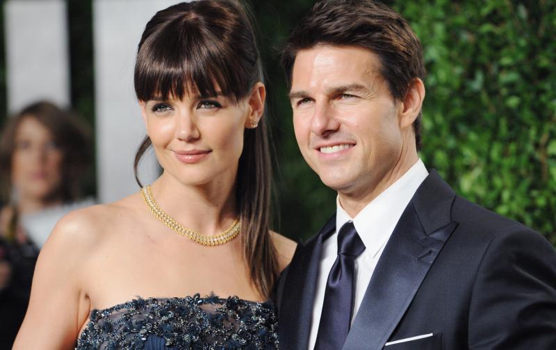 Tom Cruise and Katie Holmes posing for a photo 