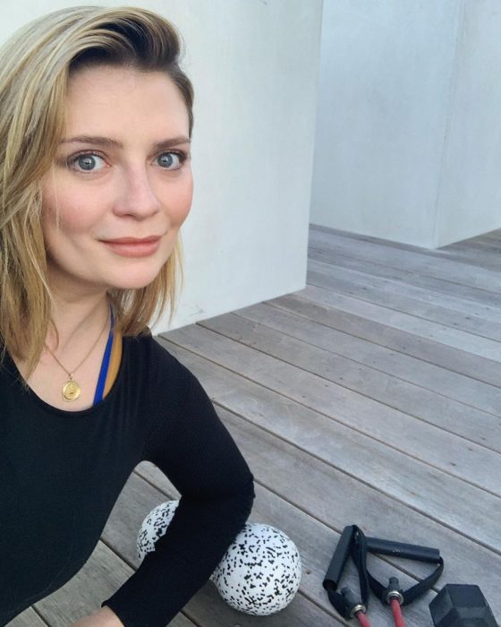 actress Mischa Barton posing while exercising at home 