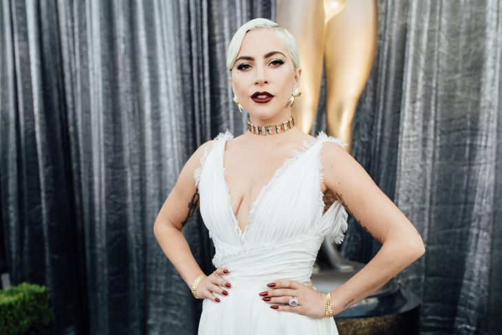 Photograph of Lady Gaga posing in a white dress on a red carpet in Los Angeles, California