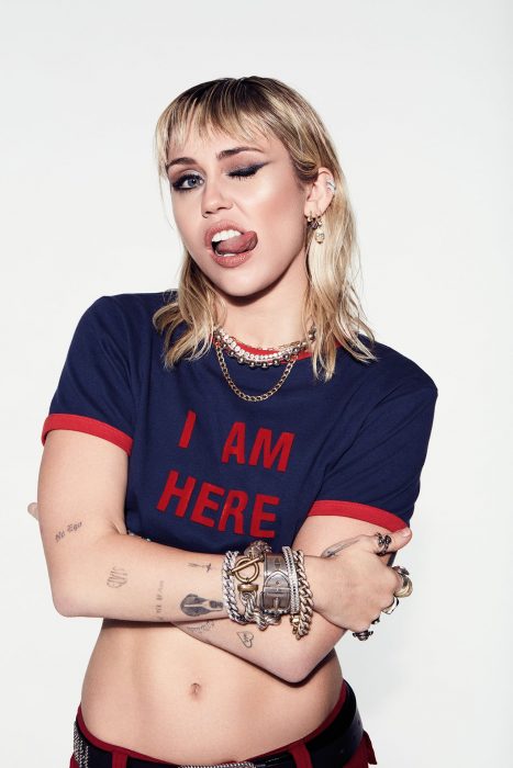 photograph of singer Miley Cyrus posing with her tongue sticking out 