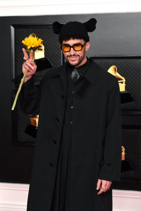 Bad Bunny with a sunflower in his hand during an awards ceremony