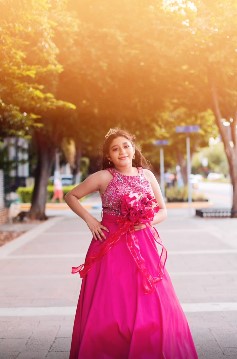 Quinceañera posando con su vestido en una sesión de fotos 