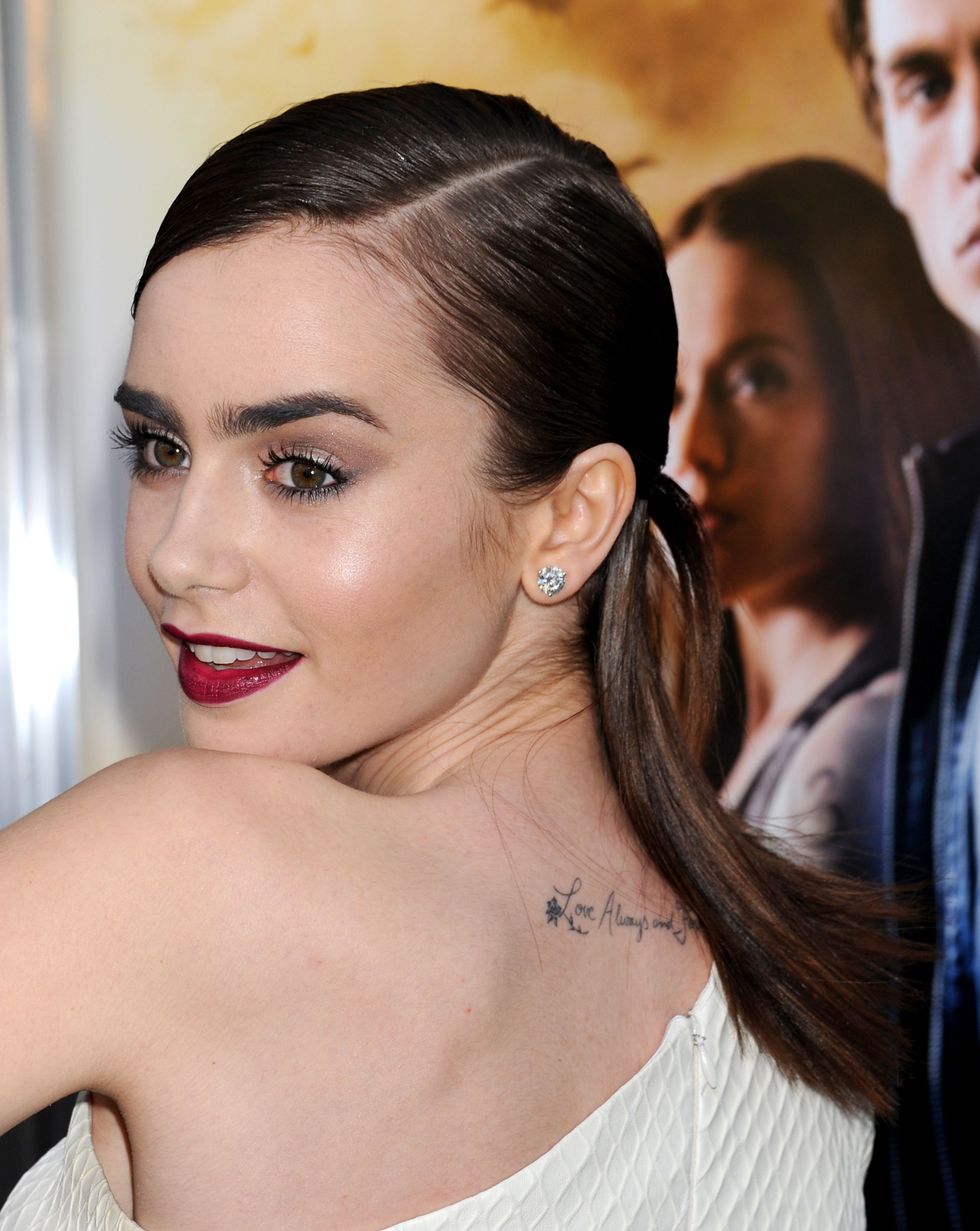 Lilly Collins with a tattoo on her back 