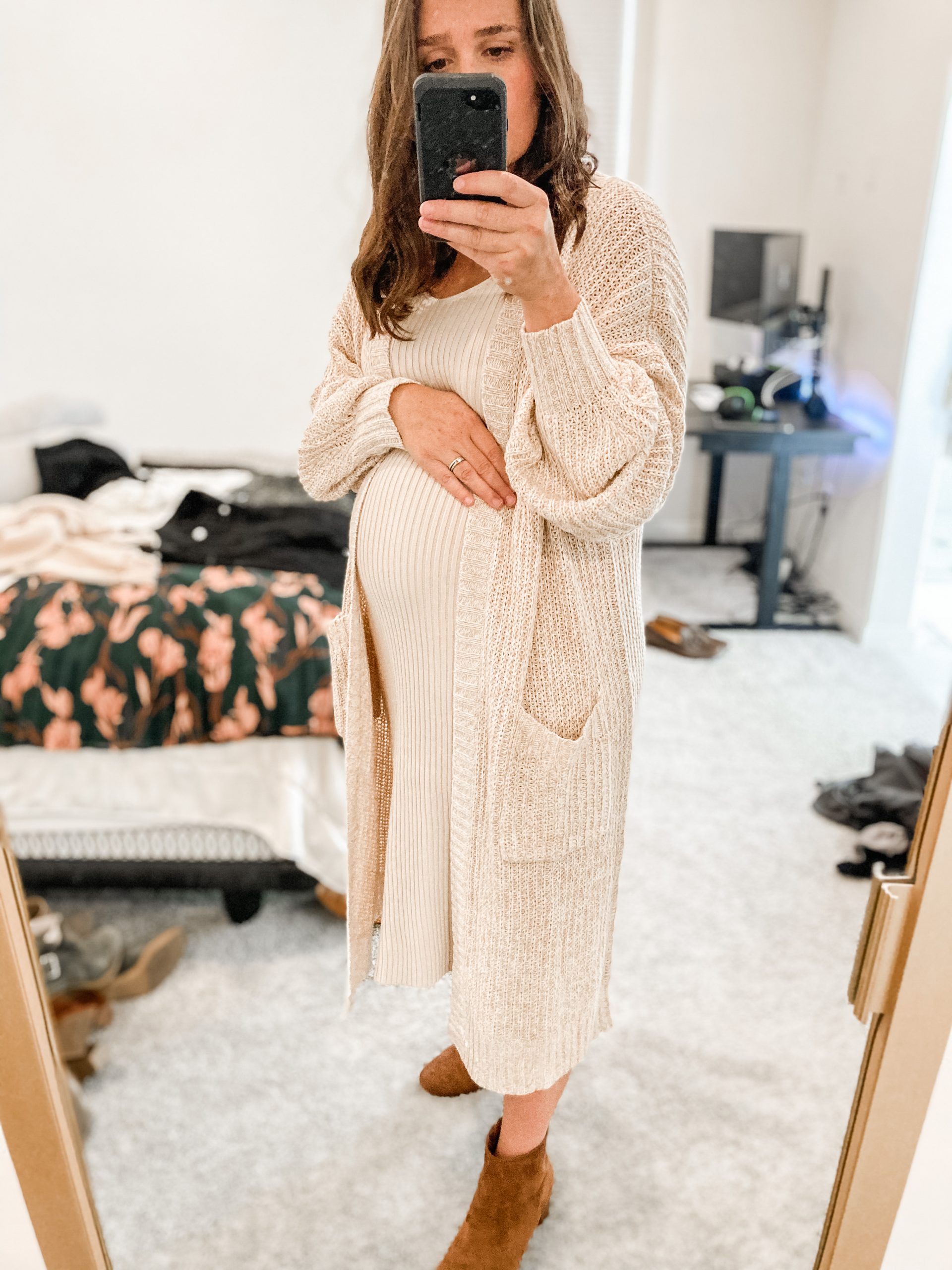 Girl wearing a winter outfit to show off her pregnancy 