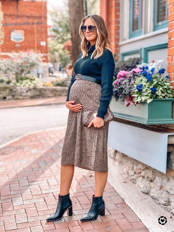 Girl wearing a winter outfit to show off her pregnancy 