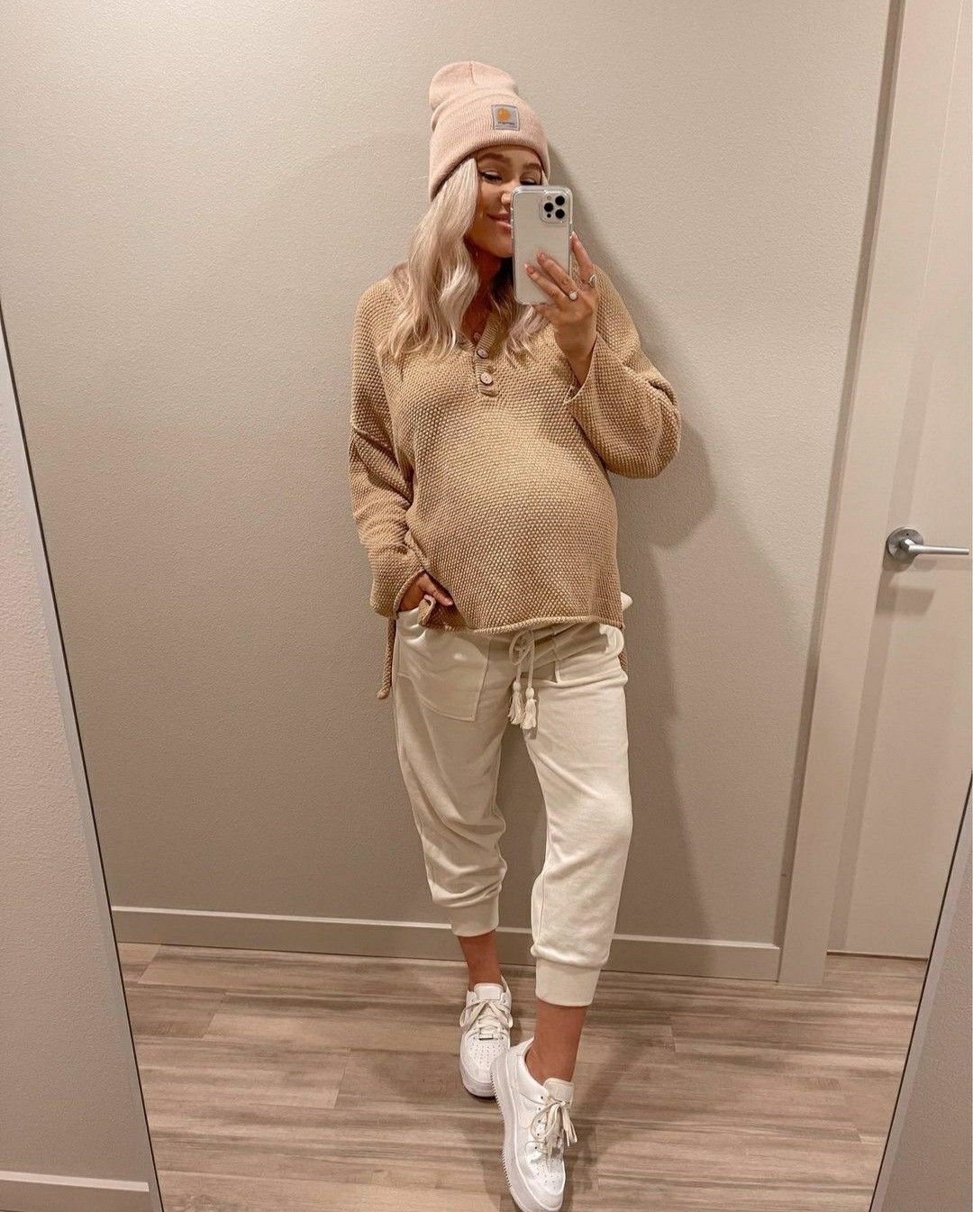 Girl wearing a winter outfit to show off her pregnancy 
