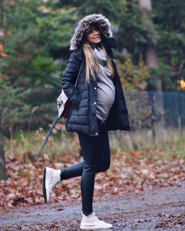 Girl wearing a winter outfit to show off her pregnancy 