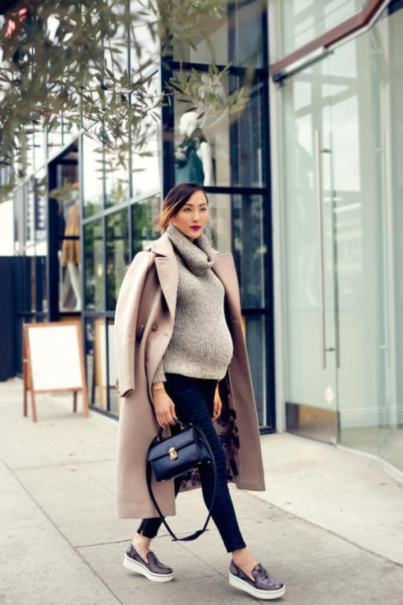Girl wearing a winter outfit to show off her pregnancy 