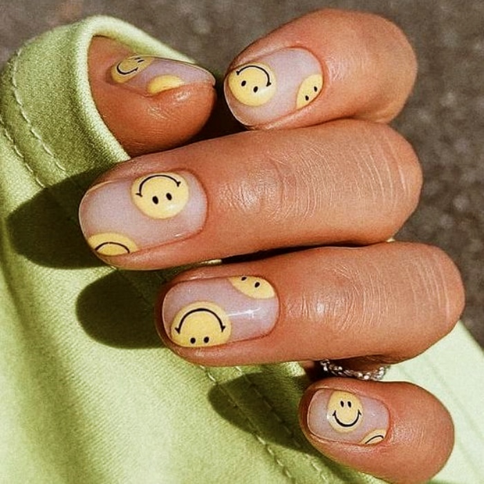 nail design with gelish, acrylics, false nails with happy faces, smiley face, in pink, blue, yellow, green and light blue