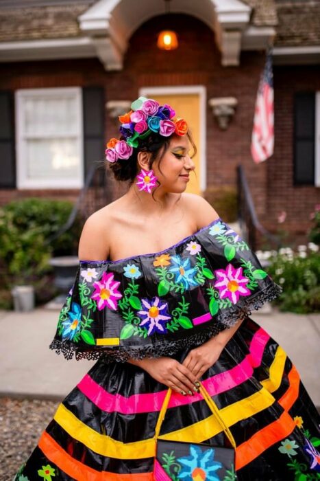 girl posing with her folkloric dress made with adhesive tape