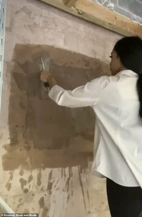 woman framing a wall 