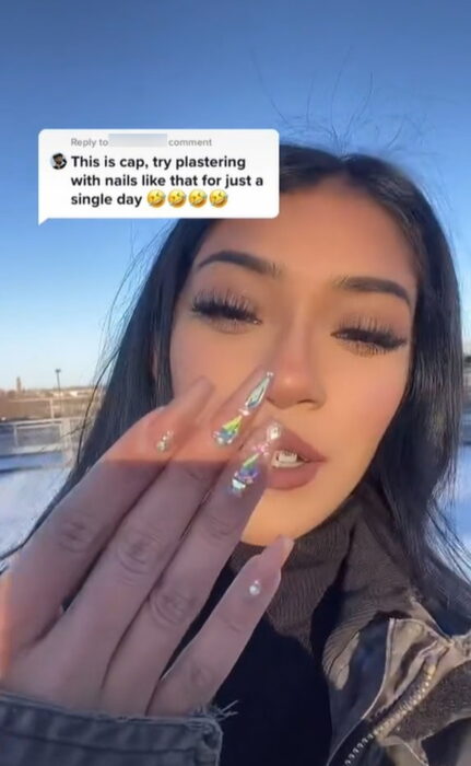 Video screenshot of a girl being judged for wearing acrylic nails while doing construction 