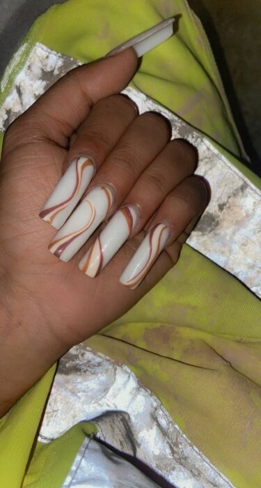 hand of a woman showing her acrylic nails 