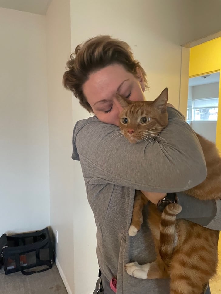 Owner hugging her cat 