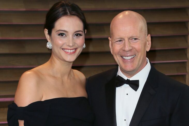 Bruce Willis and Emma Heming Willis smiling as they pose for a photograph 