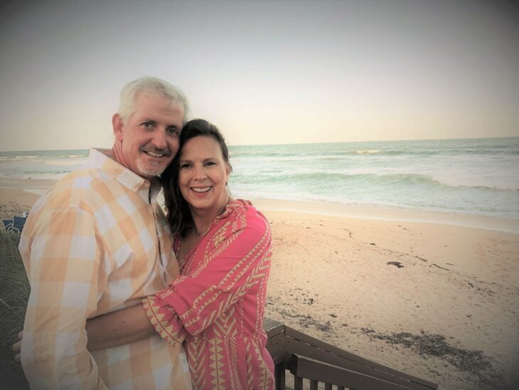 imagen de una pareja abrazándose frente a la playa 