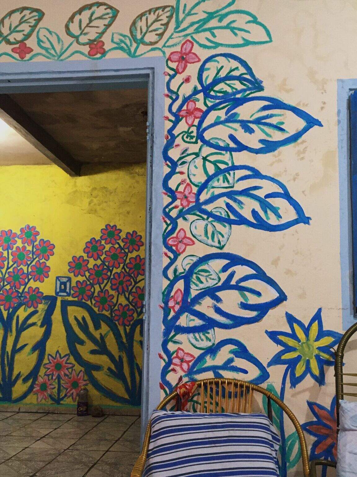 walls of a house with flowers and plants painted in different colors 