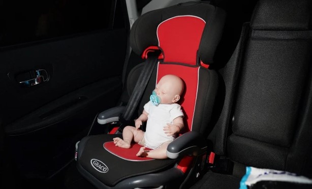 Doll sitting in a child seat 