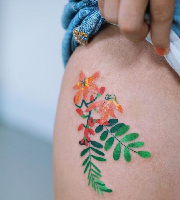 Girl showing a tattoo on her waist 