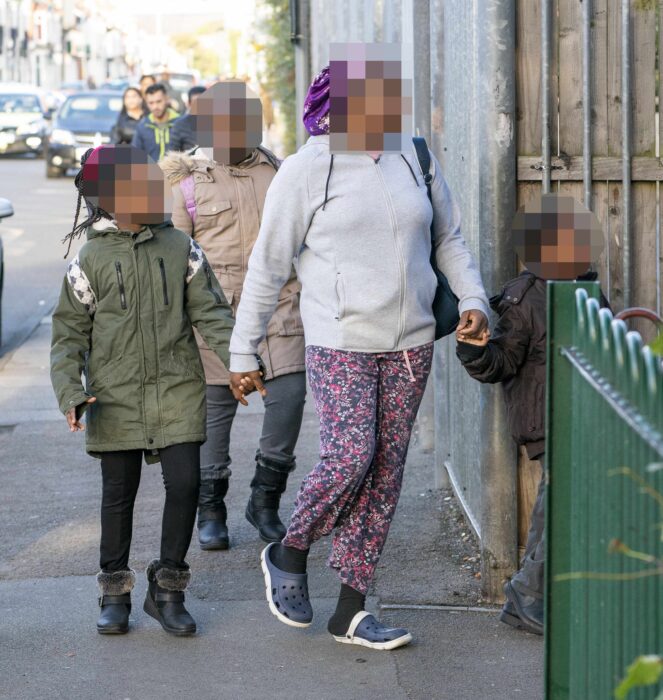 photo of a mother taking her children to school in pajamas