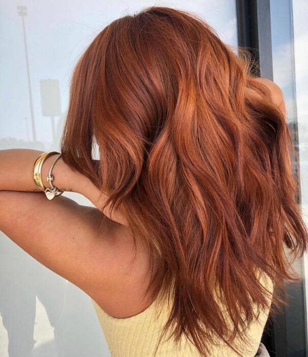 woman showing off her terracotta colored hair 