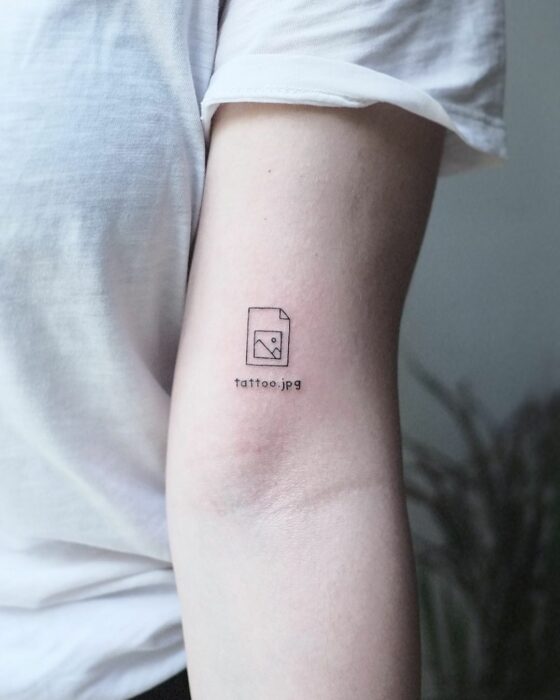 photo of a tattoo in the form of a jpg image on the arm of a girl 