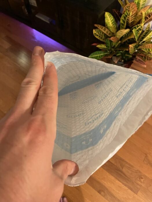 Hand showing the inside of a bag 