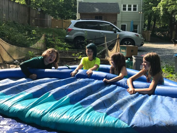 Children playing with inflatable pool