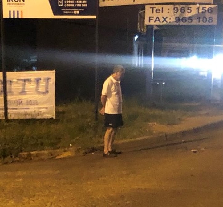 Felix Cardenas waiting at the bus stop