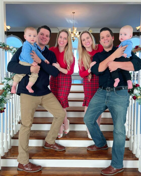 family photograph of two couples with their children on some stairs 