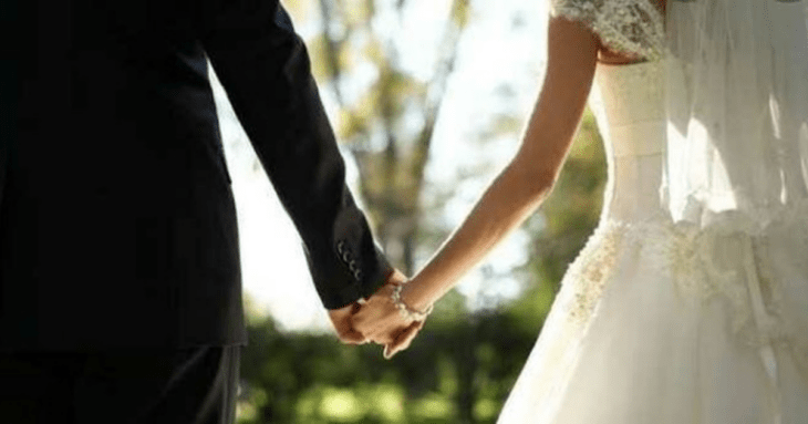 Bride and groom holding hands on their wedding day 