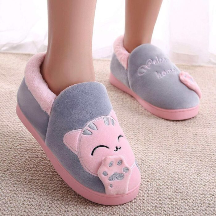 feet wearing kitty slippers in gray and pink 