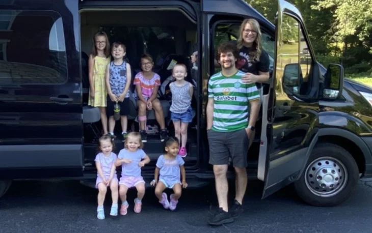 Marc, Beth, Ava, Sadie, Mia, Lucy, Nora, and her siblings in a wagon