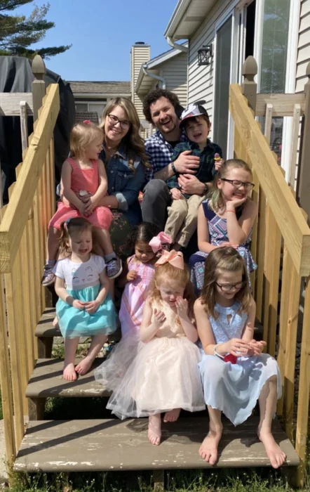 Marc, Beth, Ava, Sadie, Mia, Lucy, Nora and her siblings on some stairs