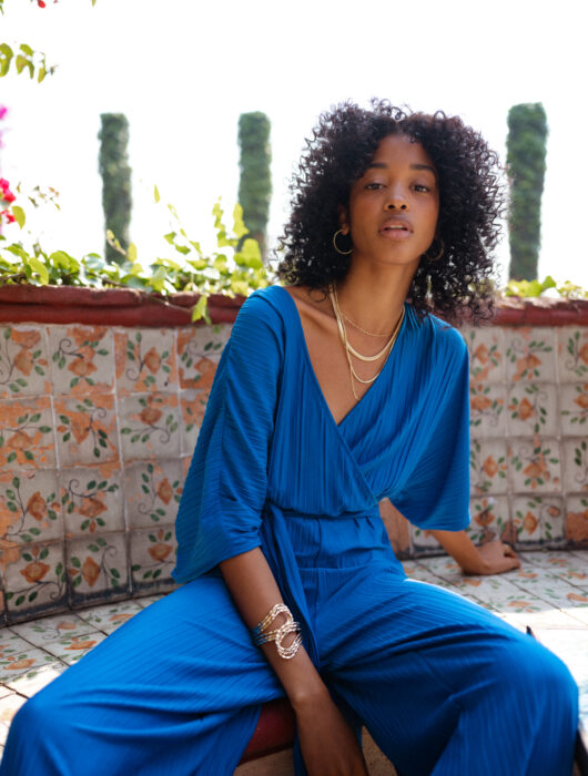 Brunette woman with Chinese hair in a blue jumpsuit