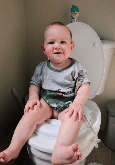 child sitting on a toilet