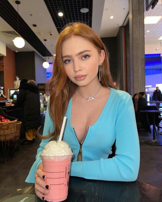 Girl drinking sitting holding a milkshake