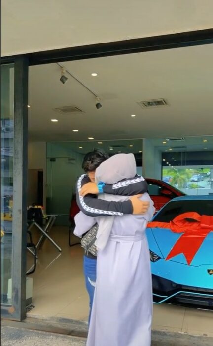 couple hugging in front of a Lamborghini 