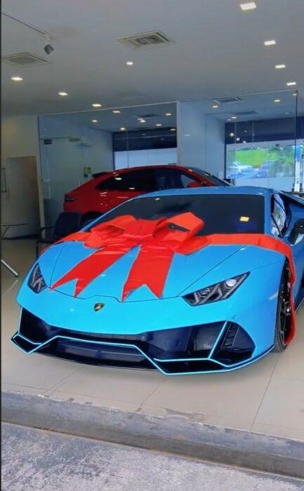 image of a turquoise Lamborghini inside a dealership 