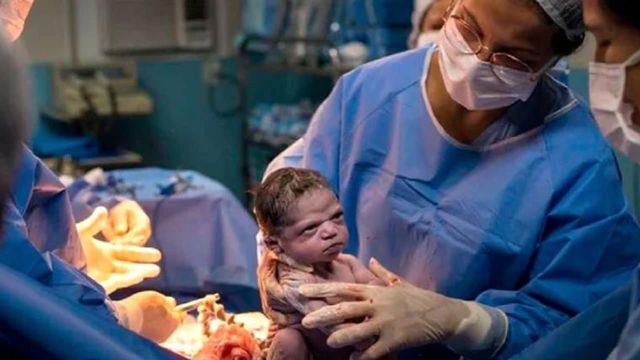 Girl coming out of the womb angry at being born