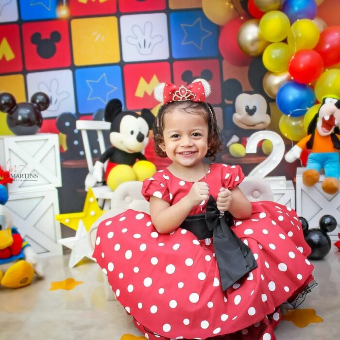 Girl who was born angry posing for a photograph dressed as minnie mouse 