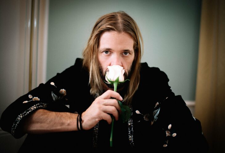 Taylor Hawkins smelling a white rose 