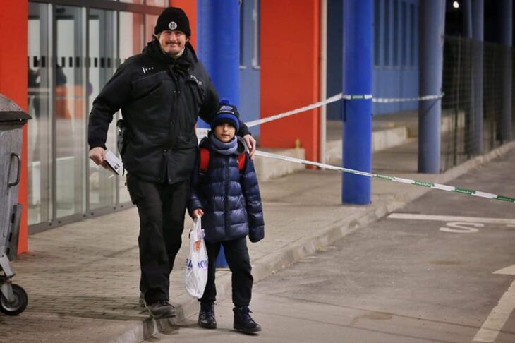 Slovakian policeman hugging a Ukrainian boy as he crosses the border 