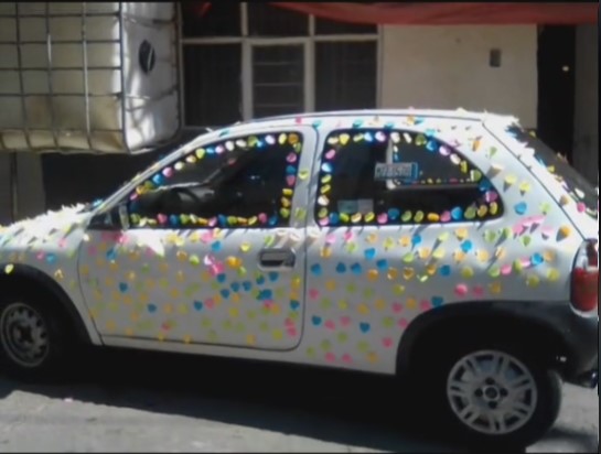 Photograph of a Chevy Pop filled with colorful Post-It Notes 